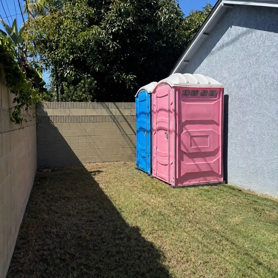 Porta potties set in a backyard