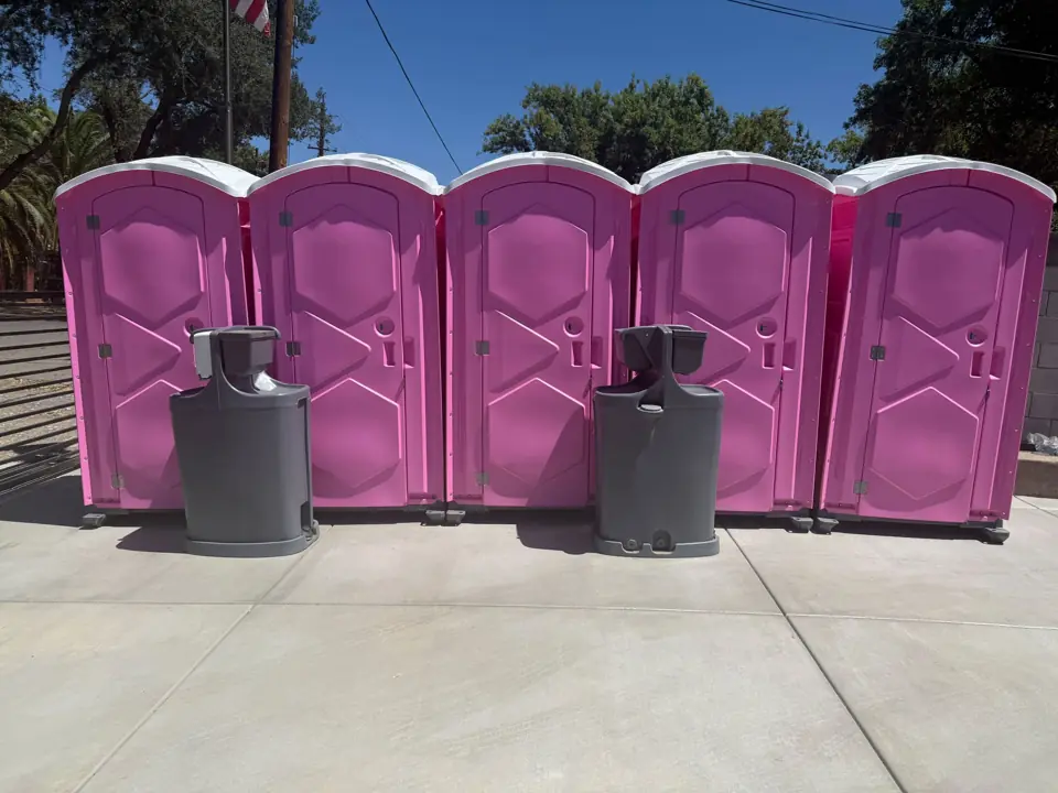 Row of porta potties with hand washing stations