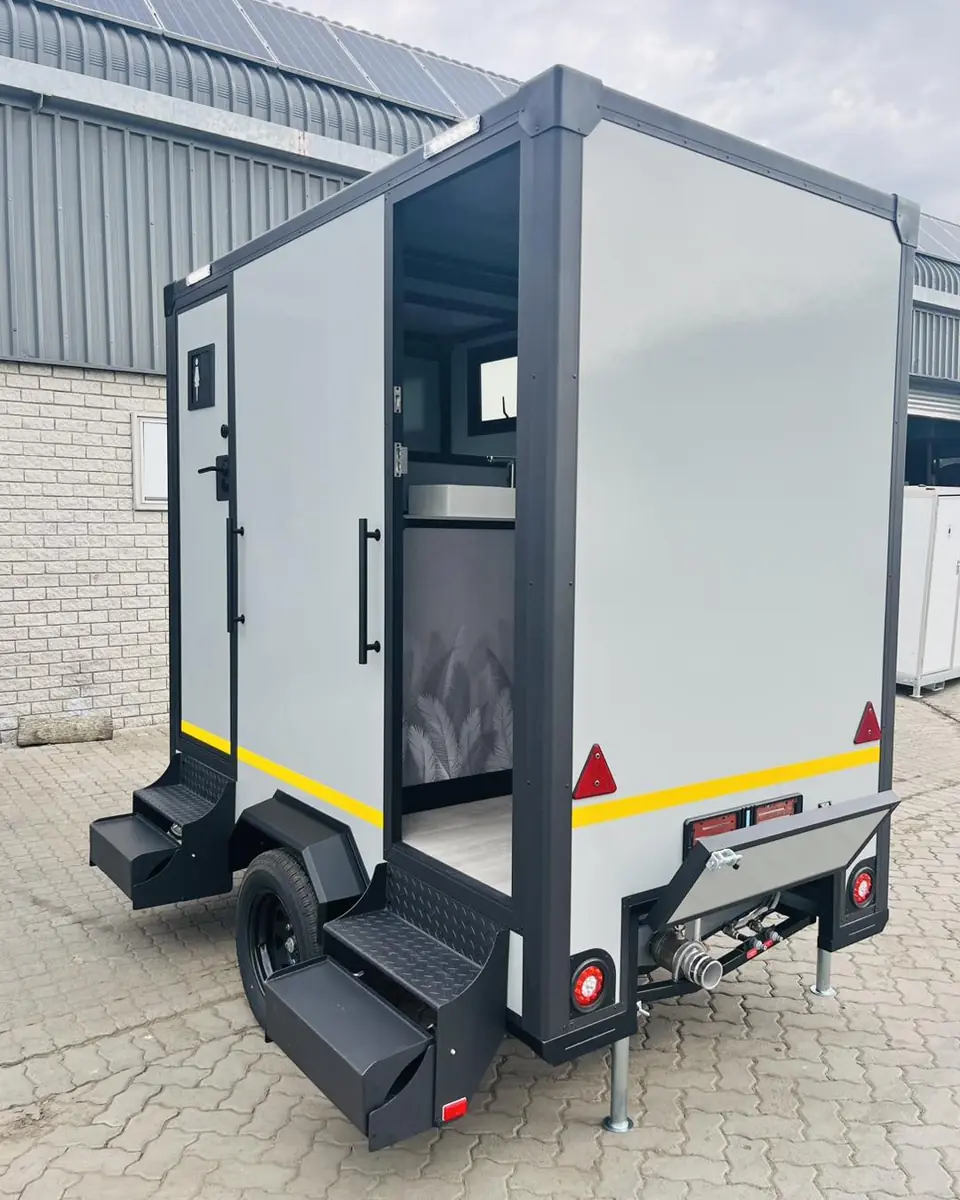 Back of a two-stall restroom trailer with fold-down entry steps