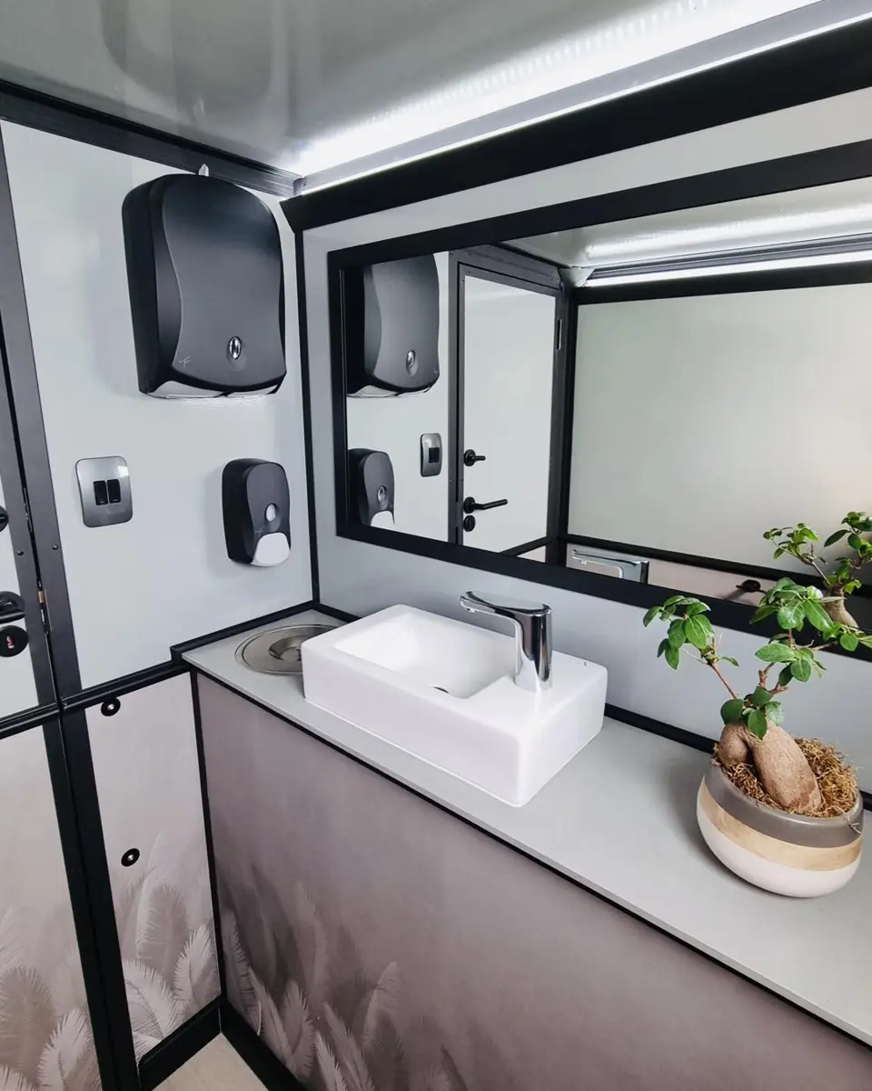 Restroom trailer vanity with vessel sink, soap and towel dispensers and mirror