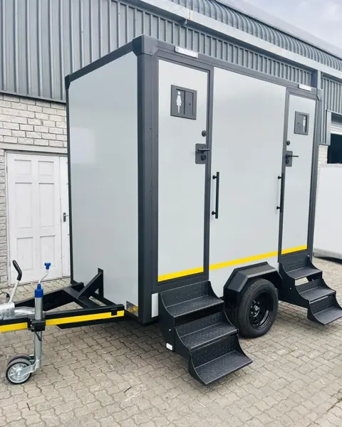 Two-stall restroom trailer with fold-down steps